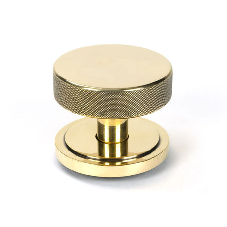 This is an image showing From The Anvil - Aged Brass Brompton Centre Door Knob (Art Deco) available from trade door handles, quick delivery and discounted prices