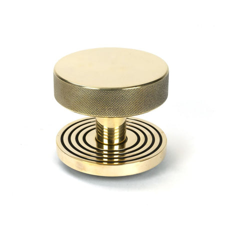 This is an image showing From The Anvil - Aged Brass Brompton Centre Door Knob (Beehive) available from trade door handles, quick delivery and discounted prices