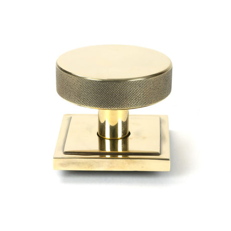 This is an image showing From The Anvil - Aged Brass Brompton Centre Door Knob (Square) available from trade door handles, quick delivery and discounted prices