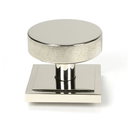 This is an image showing From The Anvil - Polished Nickel Brompton Centre Door Knob (Square) available from trade door handles, quick delivery and discounted prices
