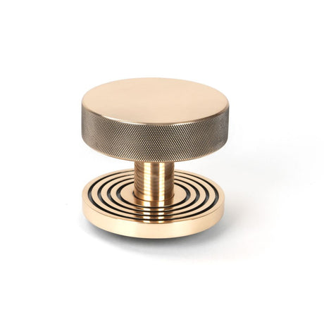 This is an image showing From The Anvil - Polished Bronze Brompton Centre Door Knob (Beehive) available from trade door handles, quick delivery and discounted prices