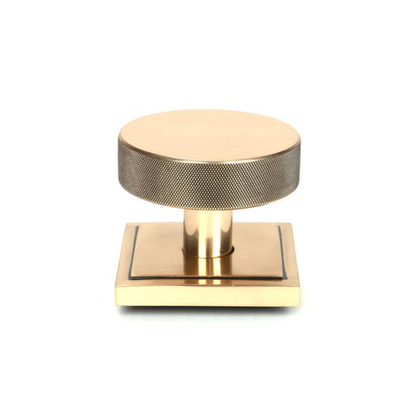 This is an image showing From The Anvil - Polished Bronze Brompton Centre Door Knob (Square) available from trade door handles, quick delivery and discounted prices