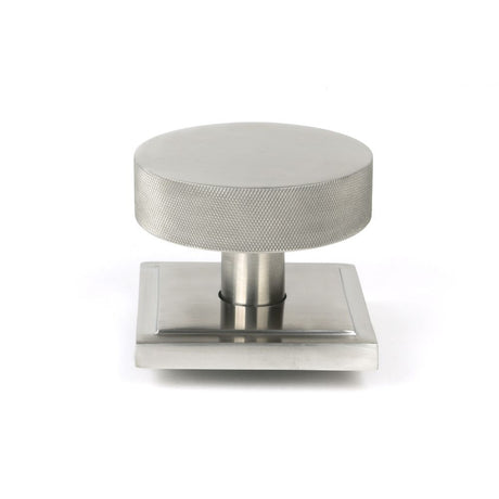 This is an image showing From The Anvil - Satin Marine SS (316) Brompton Centre Door Knob (Square) available from trade door handles, quick delivery and discounted prices