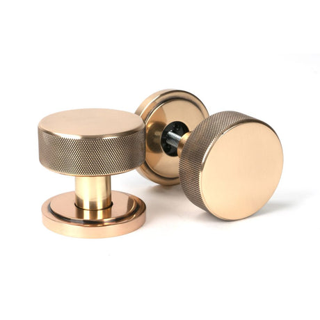 This is an image showing From The Anvil - Polished Bronze Brompton Mortice/Rim Knob Set (Art Deco) available from trade door handles, quick delivery and discounted prices