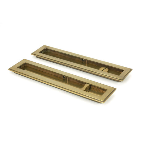 This is an image showing From The Anvil - Aged Brass 250mm Art Deco Rectangular Pull - Privacy Set available from trade door handles, quick delivery and discounted prices