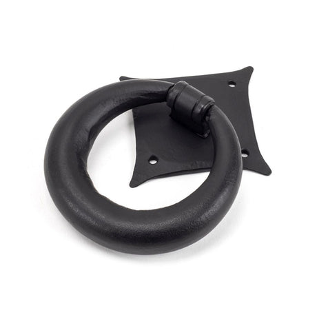 This is an image showing From The Anvil - Matt Black Ring Door Knocker available from trade door handles, quick delivery and discounted prices