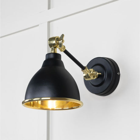 This is an image showing From The Anvil - Smooth Brass Brindley Wall Light in Elan Black available from trade door handles, quick delivery and discounted prices