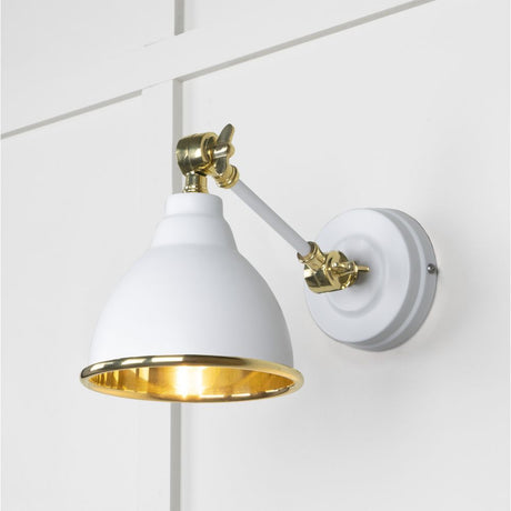 This is an image showing From The Anvil - Smooth Brass Brindley Wall Light in Flock available from trade door handles, quick delivery and discounted prices