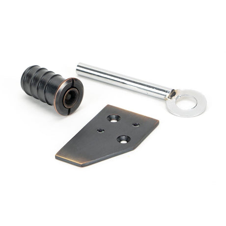 This is an image showing From The Anvil - Aged Bronze Key-Flush Sash Stop available from trade door handles, quick delivery and discounted prices
