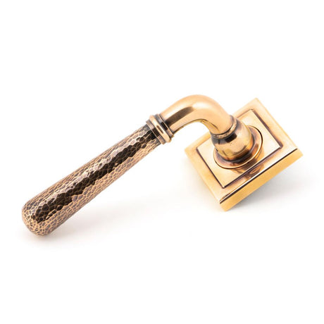 This is an image showing From The Anvil - Pol. Bronze Hammered Newbury Lever on Rose Set (Square) - Unspr available from trade door handles, quick delivery and discounted prices