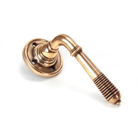 This is an image showing From The Anvil - Polished Bronze Reeded Lever on Rose Set - Unsprung available from trade door handles, quick delivery and discounted prices