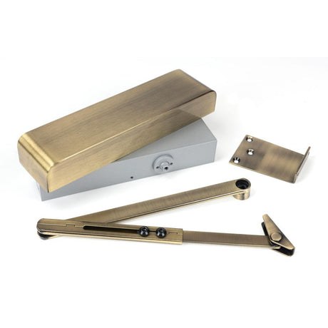 This is an image showing From The Anvil - Aged Brass Size 2-5 Door Closer & Cover available from trade door handles, quick delivery and discounted prices