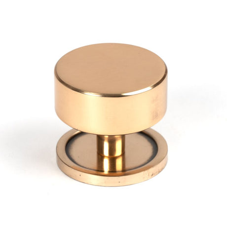 This is an image showing From The Anvil - Polished Bronze Kelso Cabinet Knob - 38mm (Plain) available from trade door handles, quick delivery and discounted prices