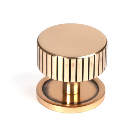 This is an image showing From The Anvil - Polished Bronze Judd Cabinet Knob - 38mm (Plain) available from trade door handles, quick delivery and discounted prices