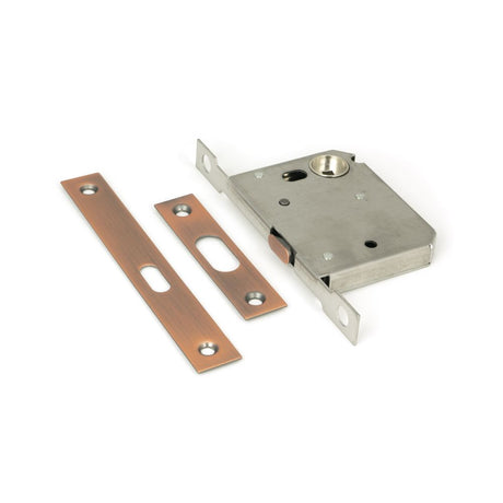 This is an image showing From The Anvil - Polished Bronze 50mm Sliding Door Lock available from trade door handles, quick delivery and discounted prices