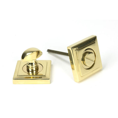 This is an image showing From The Anvil - Polished Brass Round Thumbturn Set (Square) available from trade door handles, quick delivery and discounted prices
