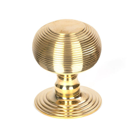 This is an image showing From The Anvil - Polished Brass Beehive Centre Door Knob available from trade door handles, quick delivery and discounted prices