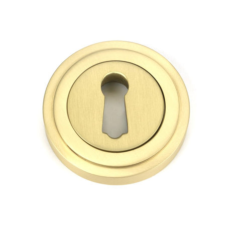 This is an image showing From The Anvil - Satin Brass Round Escutcheon (Art Deco) available from trade door handles, quick delivery and discounted prices