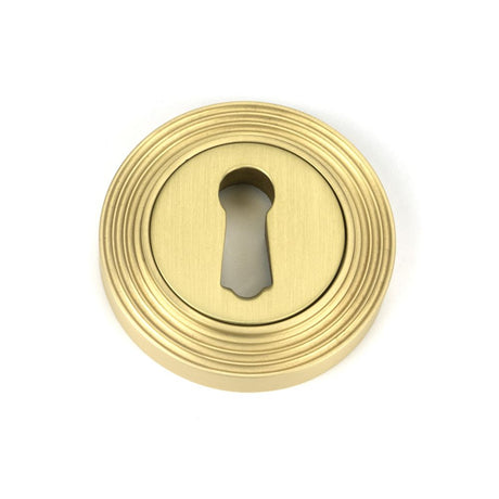 This is an image showing From The Anvil - Satin Brass Round Escutcheon (Beehive) available from trade door handles, quick delivery and discounted prices