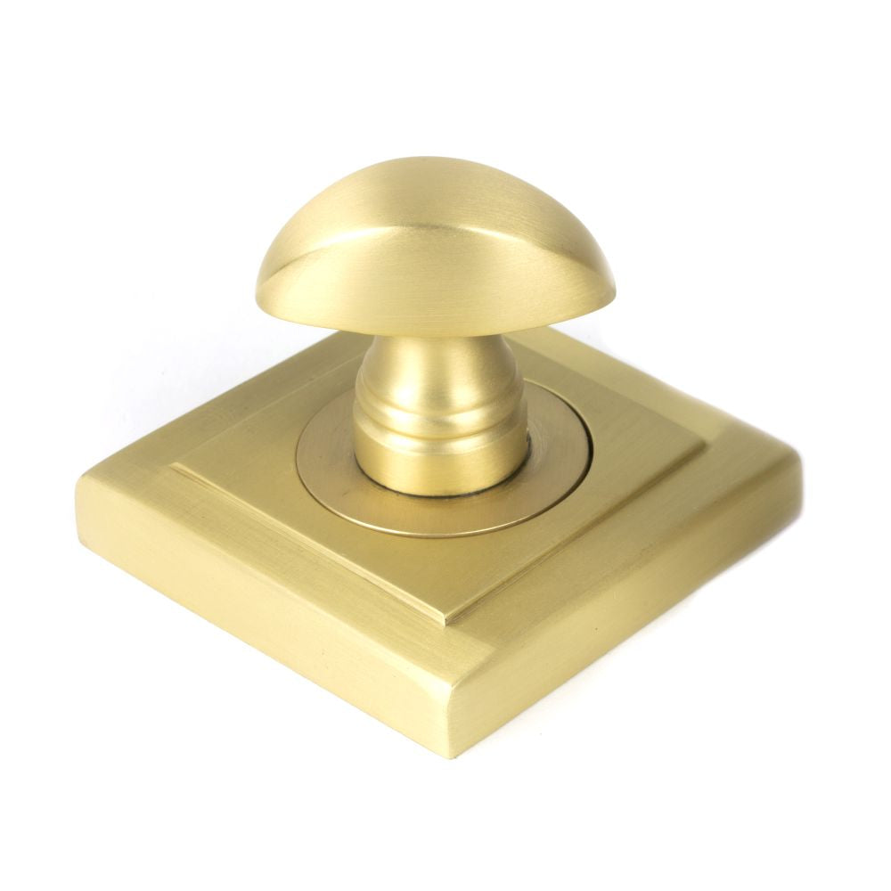 This is an image showing From The Anvil - Satin Brass Round Thumbturn Set (Square) available from trade door handles, quick delivery and discounted prices
