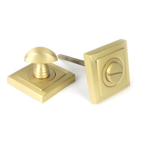 This is an image showing From The Anvil - Satin Brass Round Thumbturn Set (Square) available from trade door handles, quick delivery and discounted prices