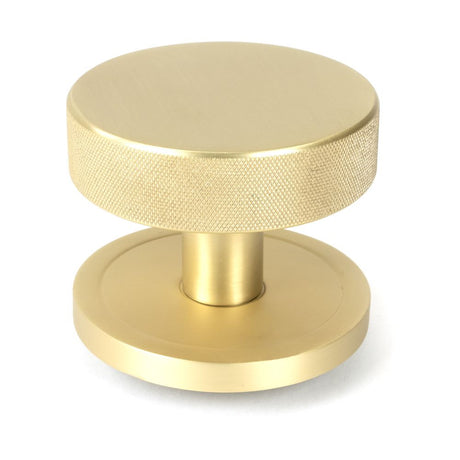 This is an image showing From The Anvil - Satin Brass Brompton Centre Door Knob (Plain) available from trade door handles, quick delivery and discounted prices