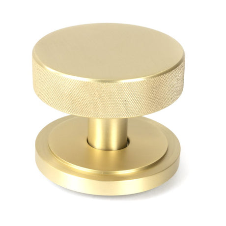 This is an image showing From The Anvil - Satin Brass Brompton Centre Door Knob (Art Deco) available from trade door handles, quick delivery and discounted prices