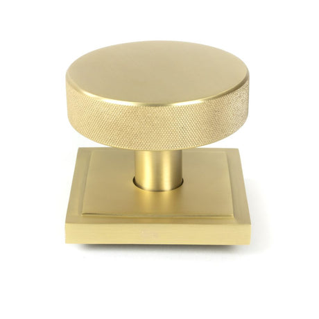This is an image showing From The Anvil - Satin Brass Brompton Centre Door Knob (Square) available from trade door handles, quick delivery and discounted prices