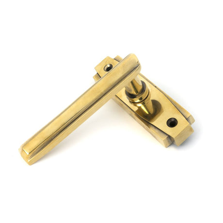 This is an image showing From The Anvil - Aged Brass Art Deco Lever on Rose Set available from trade door handles, quick delivery and discounted prices