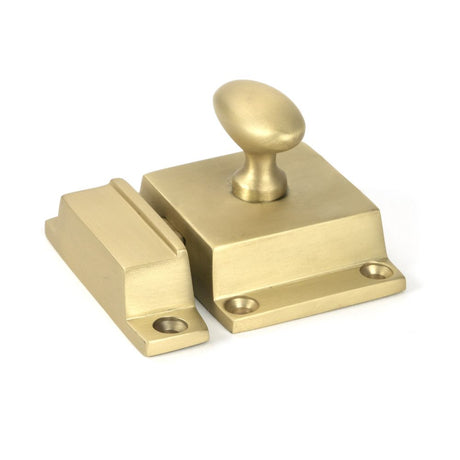This is an image showing From The Anvil - Satin Brass Cabinet Latch available from trade door handles, quick delivery and discounted prices