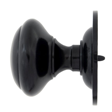 This is an image showing From The Anvil - Black Round Centre Door Knob available from trade door handles, quick delivery and discounted prices