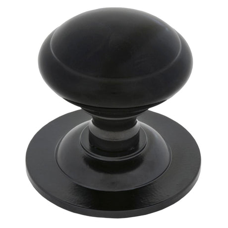 This is an image showing From The Anvil - Black Round Centre Door Knob available from trade door handles, quick delivery and discounted prices
