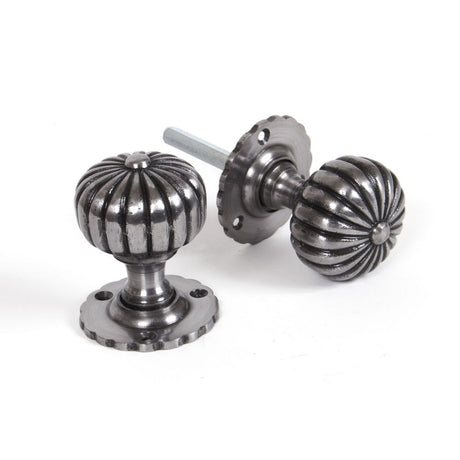 This is an image showing From The Anvil - Natural Smooth Flower Mortice Knob Set available from trade door handles, quick delivery and discounted prices