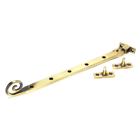 This is an image showing From The Anvil - Aged Brass 12" Monkeytail Stay available from trade door handles, quick delivery and discounted prices