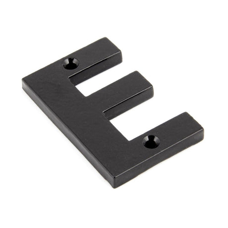 This is an image showing From The Anvil - Black Letter E available from trade door handles, quick delivery and discounted prices