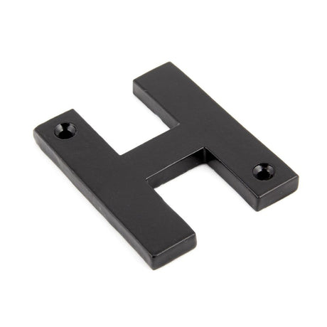 This is an image showing From The Anvil - Black Letter H available from trade door handles, quick delivery and discounted prices
