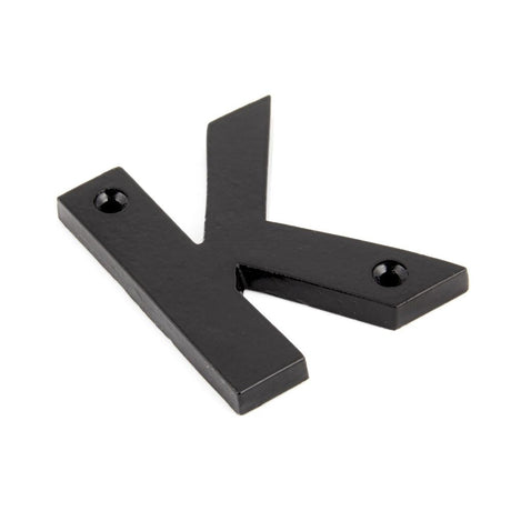 This is an image showing From The Anvil - Black Letter K available from trade door handles, quick delivery and discounted prices