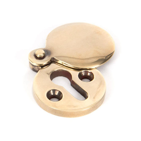 This is an image showing From The Anvil - Aged Brass 30mm Round Escutcheon available from trade door handles, quick delivery and discounted prices