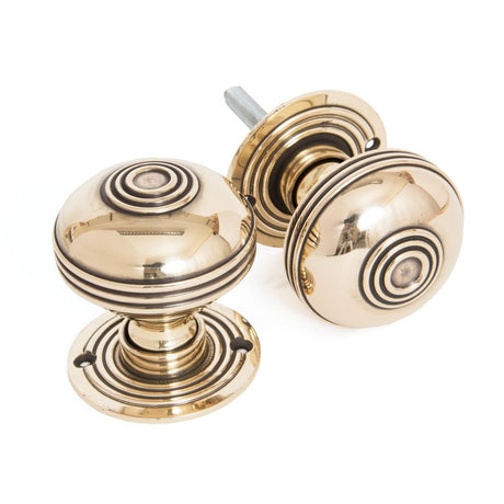 This is an image showing From The Anvil - Aged Brass 63mm Prestbury Mortice/Rim Knob Set available from trade door handles, quick delivery and discounted prices