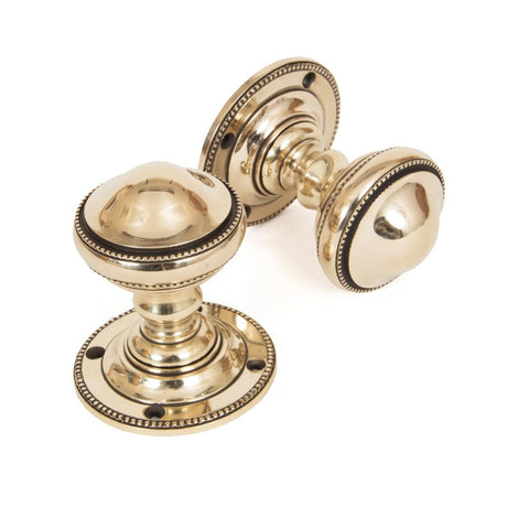 This is an image showing From The Anvil - Aged Brass Brockworth Mortice Knob Set available from trade door handles, quick delivery and discounted prices