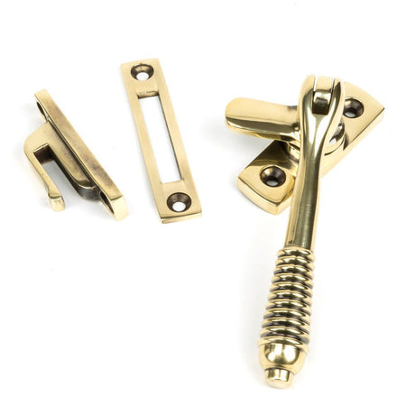 This is an image showing From The Anvil - Aged Brass Locking Reeded Fastener available from trade door handles, quick delivery and discounted prices