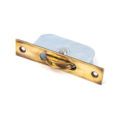 This is an image showing From The Anvil - Aged Brass Square Ended Sash Pulley 75kg available from trade door handles, quick delivery and discounted prices