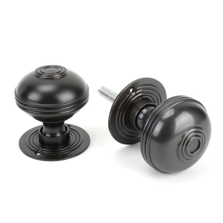 This is an image showing From The Anvil - Aged Bronze 63mm Prestbury Mortice/Rim Knob Set available from trade door handles, quick delivery and discounted prices
