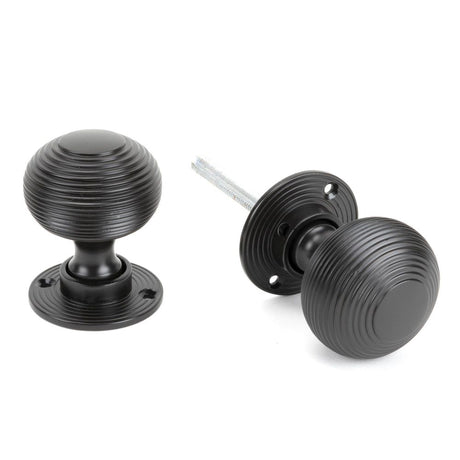 This is an image showing From The Anvil - Aged Bronze Heavy Beehive Mortice/Rim Knob Set available from trade door handles, quick delivery and discounted prices