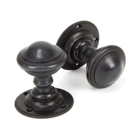 This is an image showing From The Anvil - Aged Bronze Brockworth Mortice Knob Set available from trade door handles, quick delivery and discounted prices
