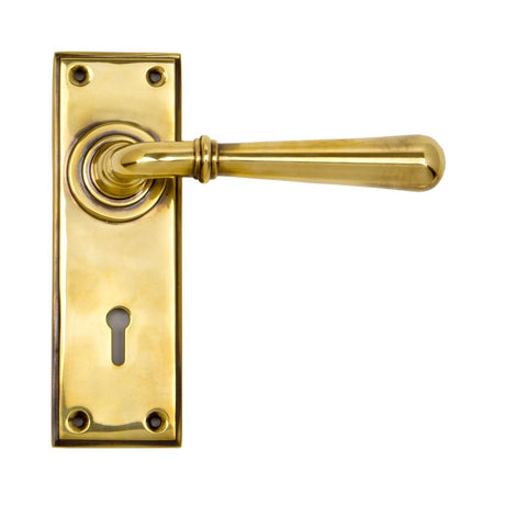 This is an image showing From The Anvil - Aged Brass Newbury Lever Lock Set available from trade door handles, quick delivery and discounted prices