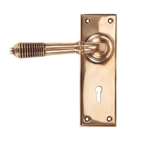 This is an image showing From The Anvil - Polished Bronze Reeded Lever Lock Set available from trade door handles, quick delivery and discounted prices