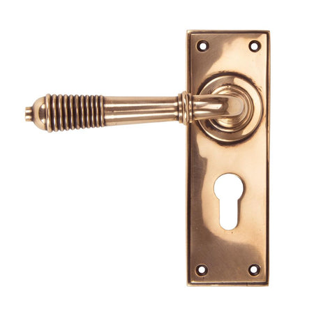 This is an image showing From The Anvil - Polished Bronze Reeded Lever Euro Lock Set available from trade door handles, quick delivery and discounted prices