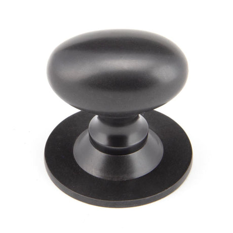 This is an image showing From The Anvil - Aged Bronze Oval Cabinet Knob 40mm available from trade door handles, quick delivery and discounted prices