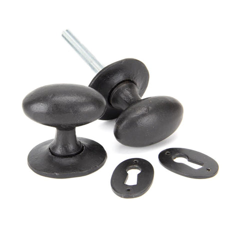 This is an image showing From The Anvil - External Beeswax Oval Mortice/Rim Knob Set available from trade door handles, quick delivery and discounted prices
